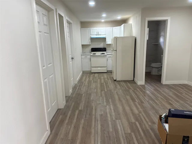 a kitchen with a refrigerator a sink and cabinets