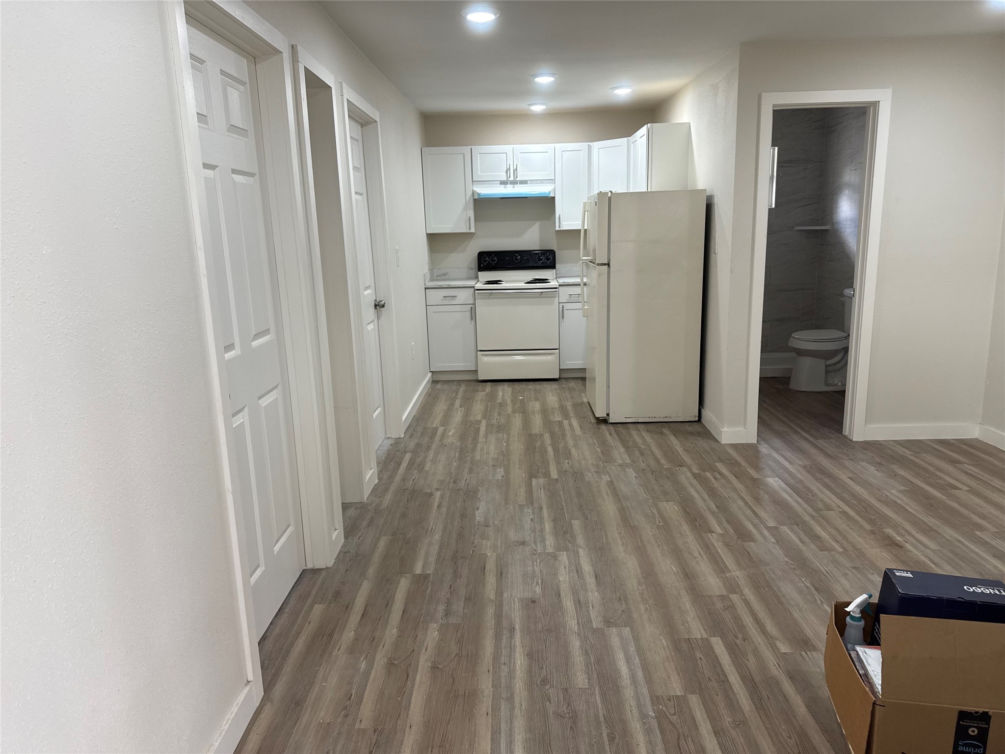 2434 Lidstone Street, Unit ST Houston, TX 77023 - Photo 4 of 8 a kitchen with a refrigerator a sink and cabinets