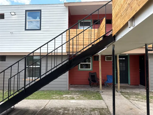 a view of a house with wooden floor and fence