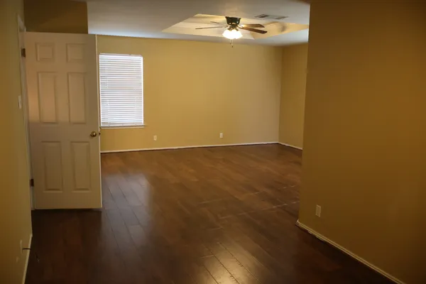 an empty room with wooden floor and closet