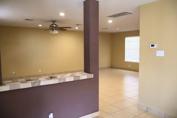 a view of kitchen with stainless steel appliances granite countertop cabinets and window