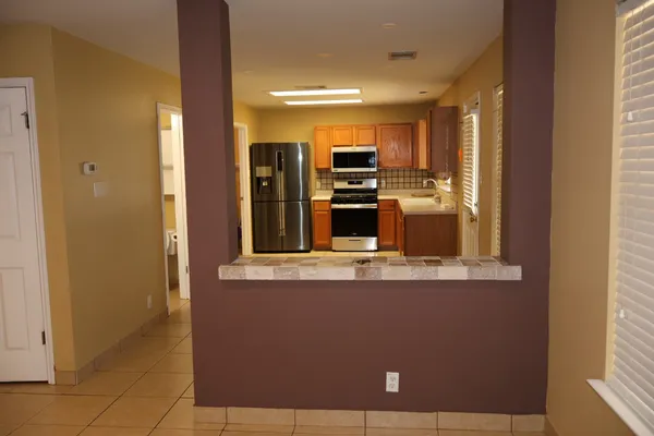 a large kitchen with a stove a refrigerator and a sink
