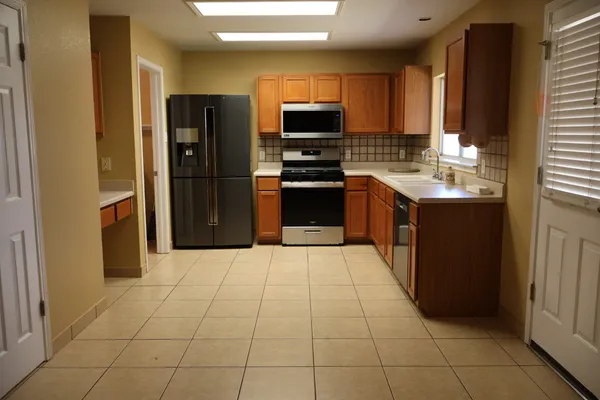 a kitchen with a sink stove and refrigerator