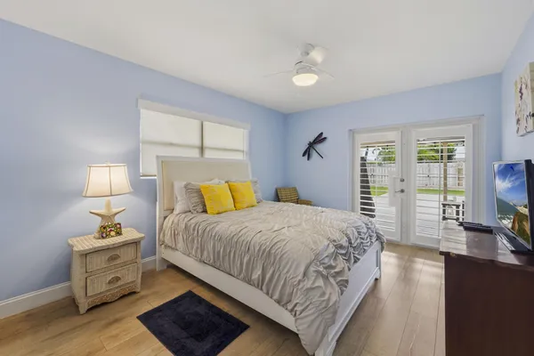a bedroom with a bed and wooden floor