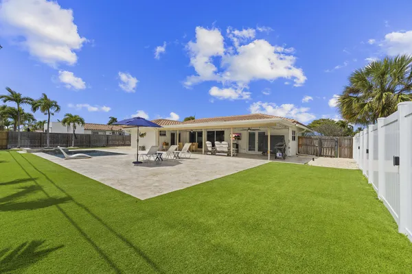 a view of yard with swimming pool outdoor seating and yard in back