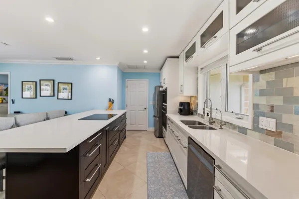 a large kitchen with stainless steel appliances a lot of counter space and a sink