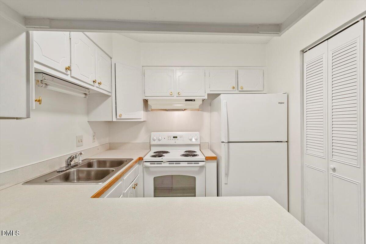 1217 H Manassas Court, Unit H Raleigh, NC 27609 - Photo 12 of 30 a kitchen with a white cabinets and white appliances
