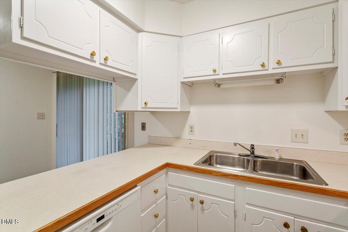 1217 H Manassas Court, Unit H Raleigh, NC 27609 - Photo 13 of 30 a kitchen with a sink and cabinets