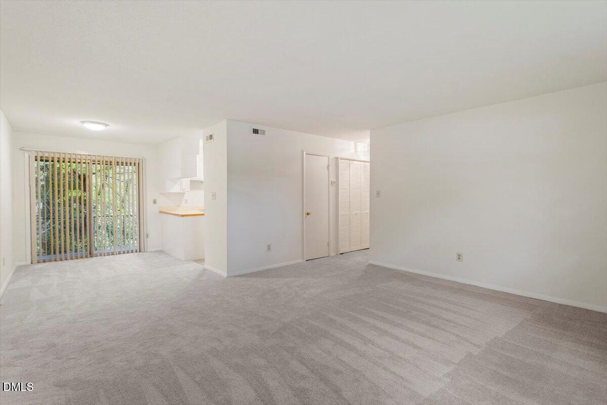 1217 H Manassas Court, Unit H Raleigh, NC 27609 - Photo 16 of 30 a view of an empty room with a window