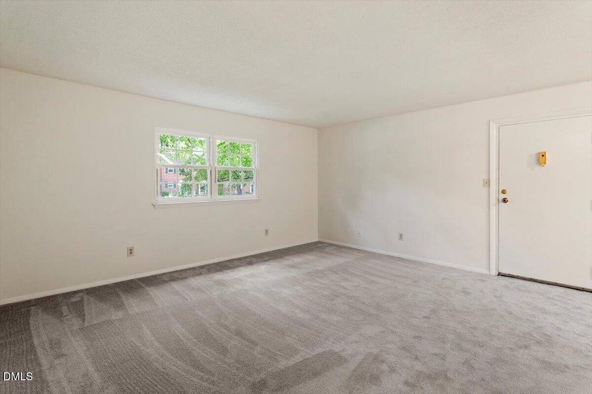 1217 H Manassas Court, Unit H Raleigh, NC 27609 - Photo 18 of 30 an empty room with windows