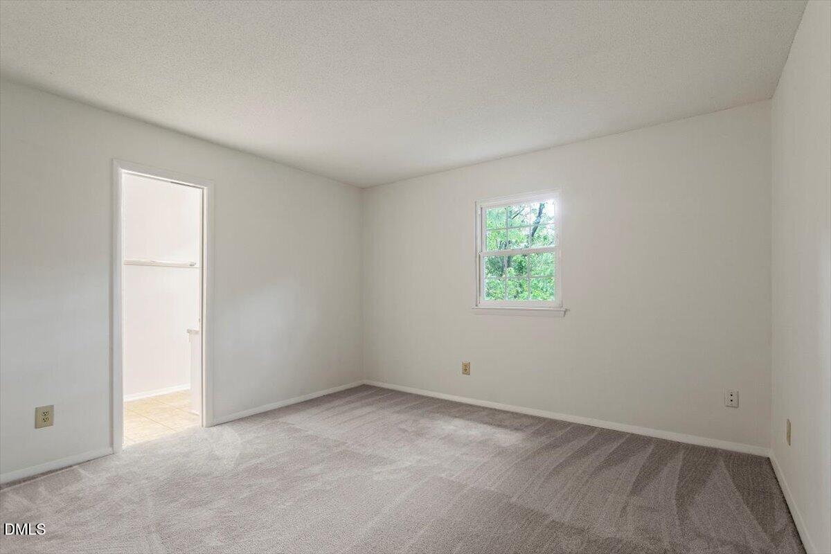1217 H Manassas Court, Unit H Raleigh, NC 27609 - Photo 24 of 30 an empty room with windows