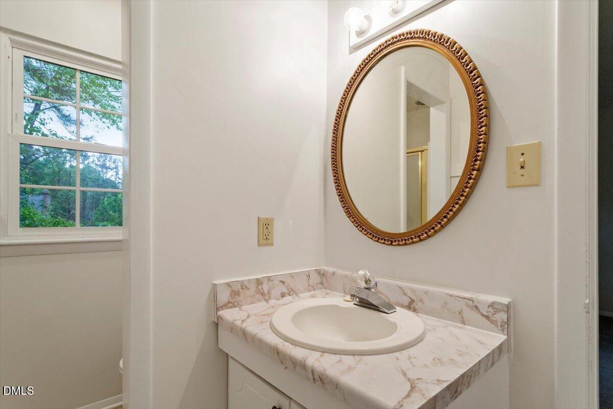 1217 H Manassas Court, Unit H Raleigh, NC 27609 - Photo 25 of 30 a bathroom with a sink and a mirror