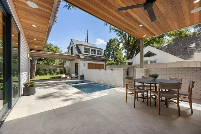 a view of a patio with table and chairs and potted plants