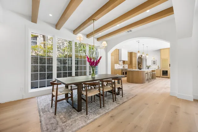 a view of a dining room with furniture large windows and wooden floor