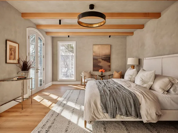 a bedroom with a bed and a lamp