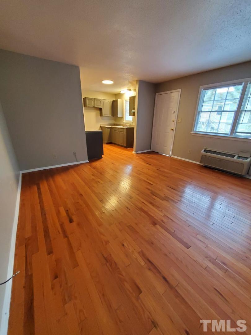 1011 Morreene Road, Unit 31 Durham, NC 27705 - Photo 3 of 5 a view of empty room with wooden floor and fan