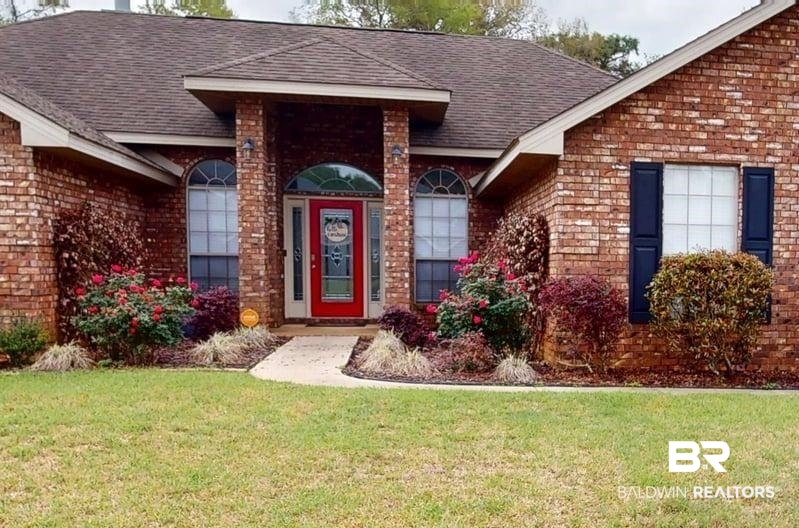 10753 Rigby Drive Mobile, AL 36695 - Photo 2 of 33 Entrance to property featuring a lawn, brick siding, and roof with shingles
