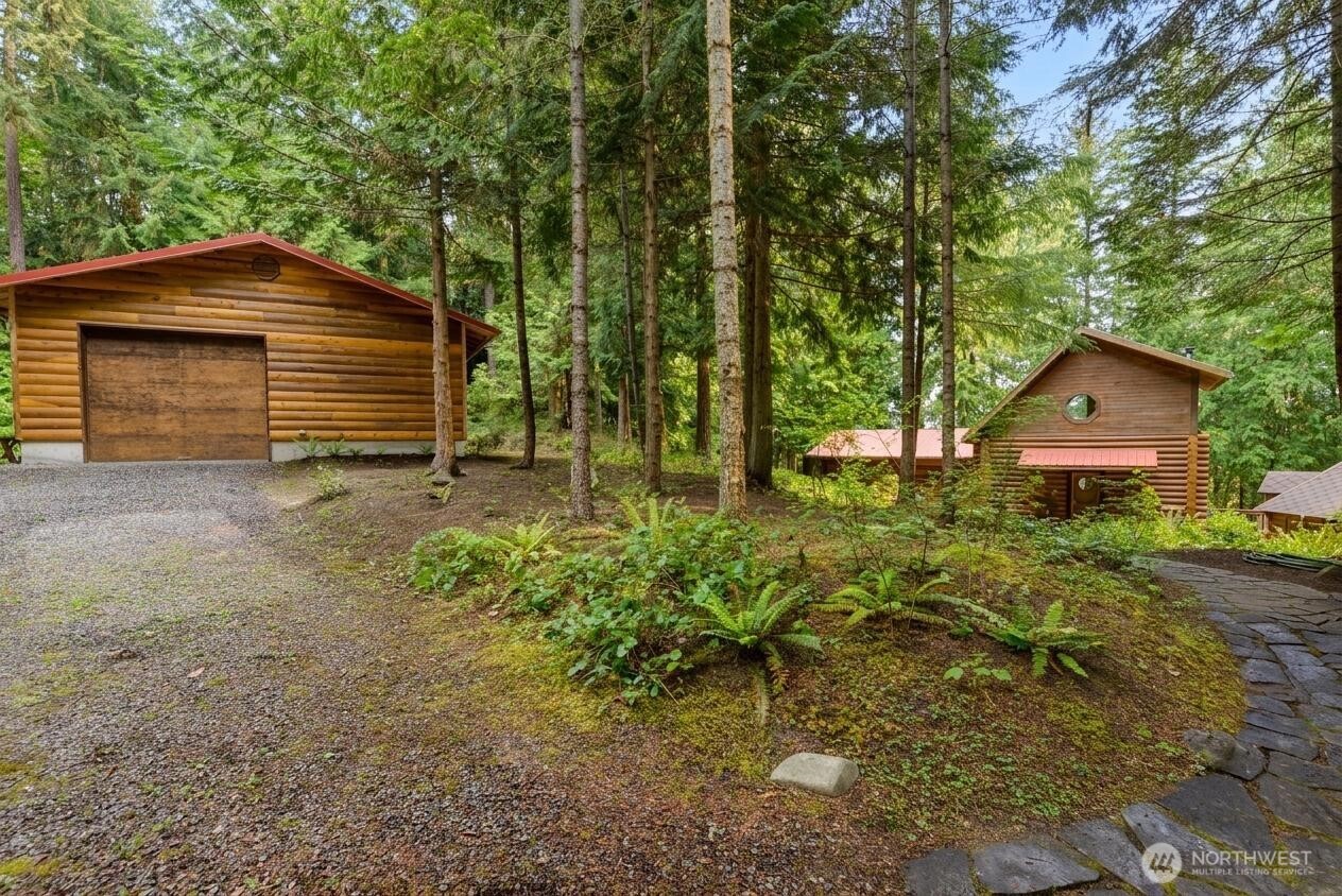 214 Cougar Crest Road Sequim, WA 98382 - Photo 22 of 30 a backyard of a house with lots of green space