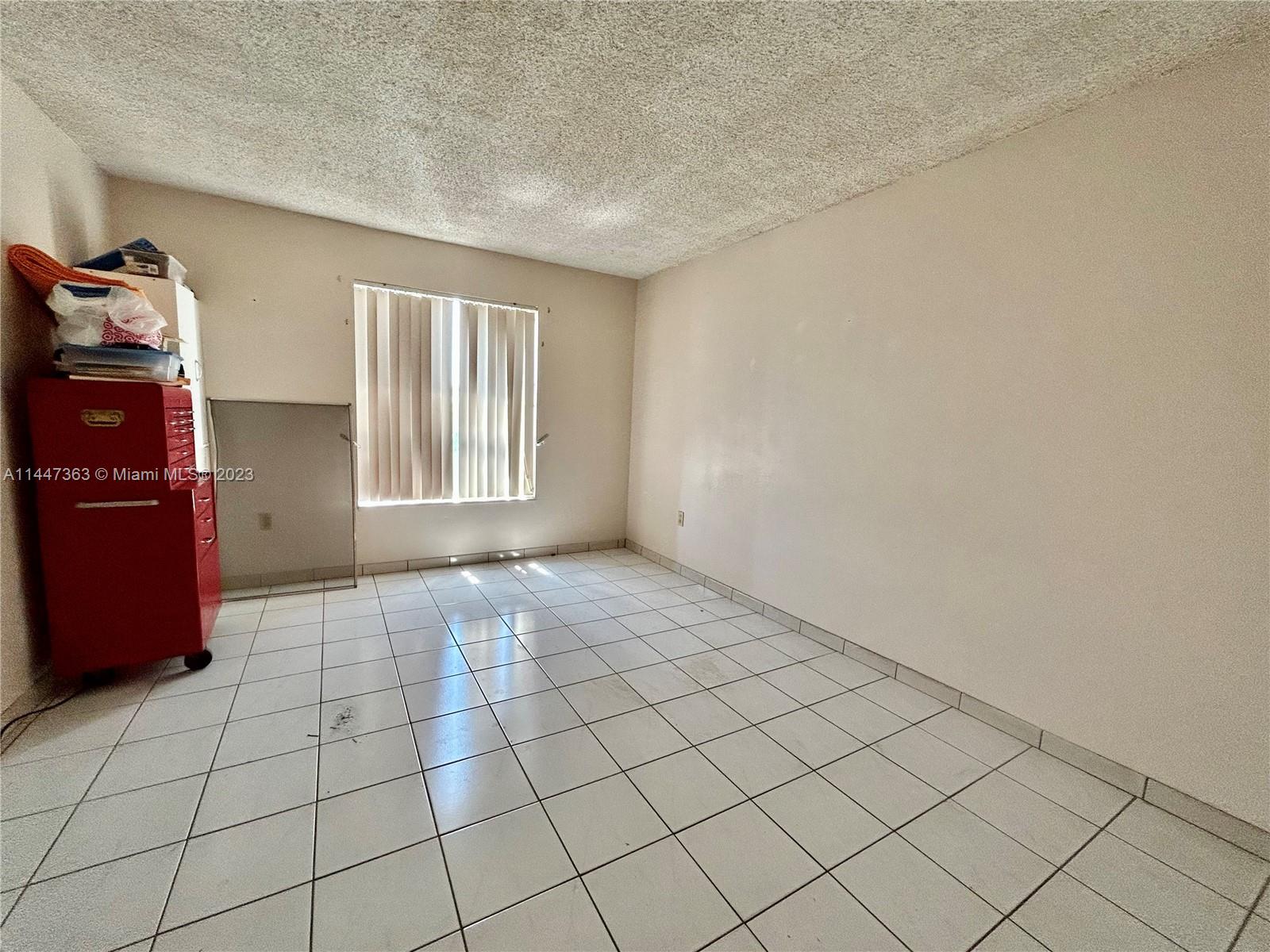 5201 Northwest 7th Street, Unit 403 Miami, FL 33126 - Photo 11 of 17 a view of an empty room and window