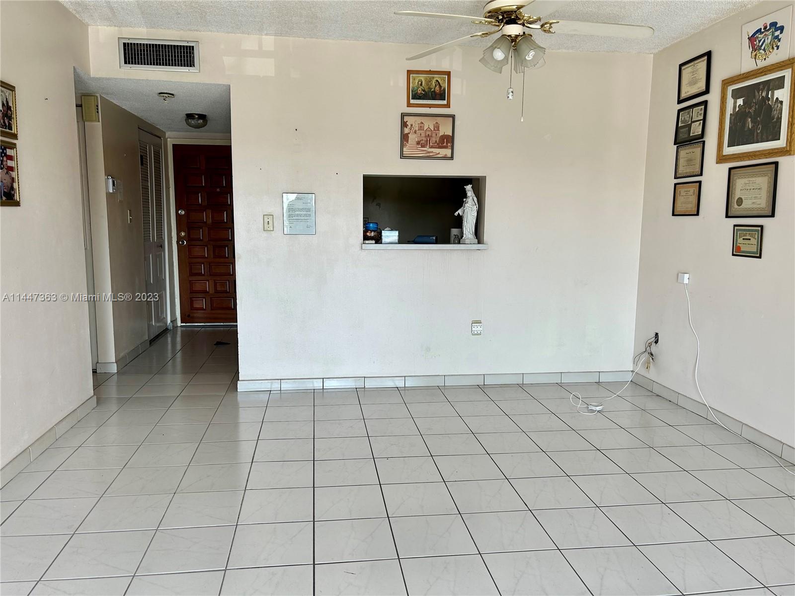 5201 Northwest 7th Street, Unit 403 Miami, FL 33126 - Photo 13 of 17 a view of a livingroom with an empty space and a fireplace