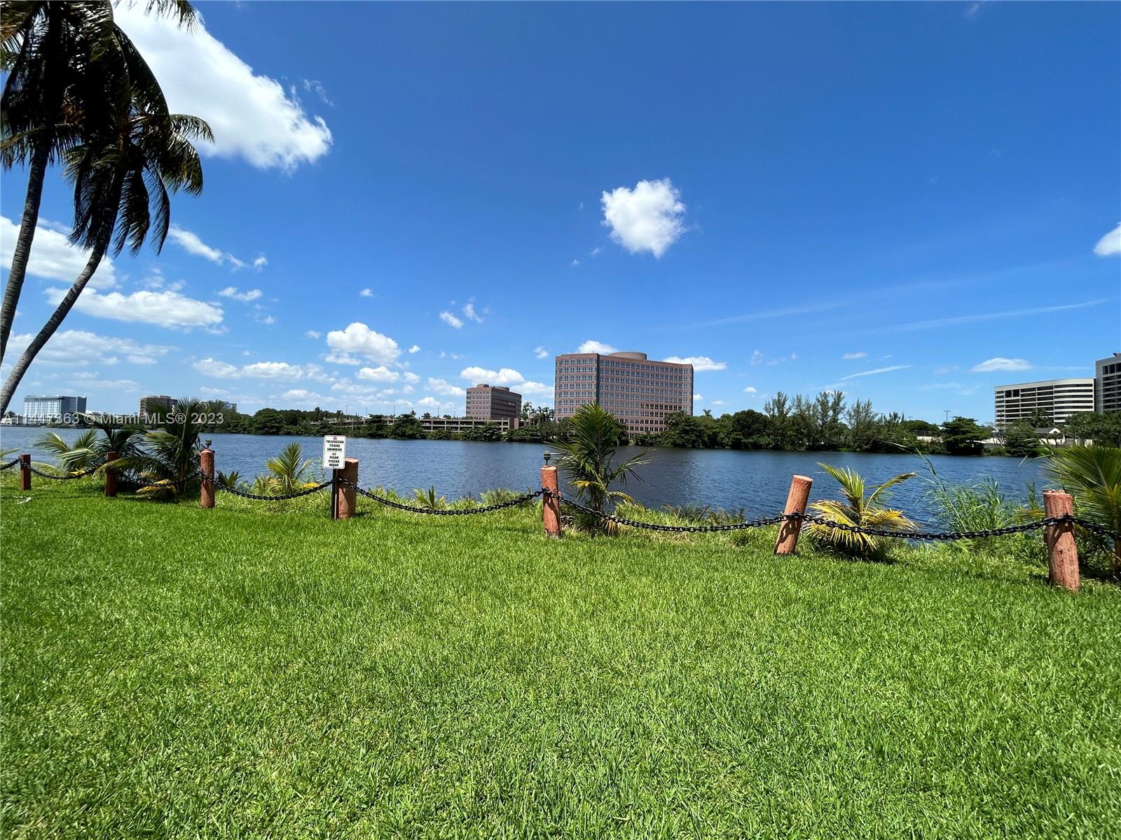 5201 Northwest 7th Street, Unit 403 Miami, FL 33126 - Photo 2 of 17 a view of a lake and front yard