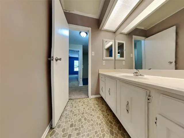 a bathroom with a double vanity sink and a mirror