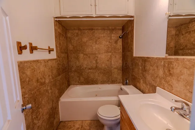 a bathroom with a toilet sink and bathtub