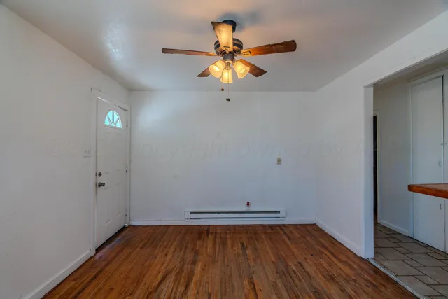 a view of a room with wooden floor