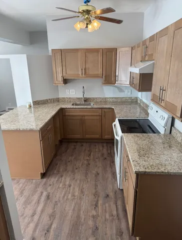 a kitchen with a sink stove and cabinets