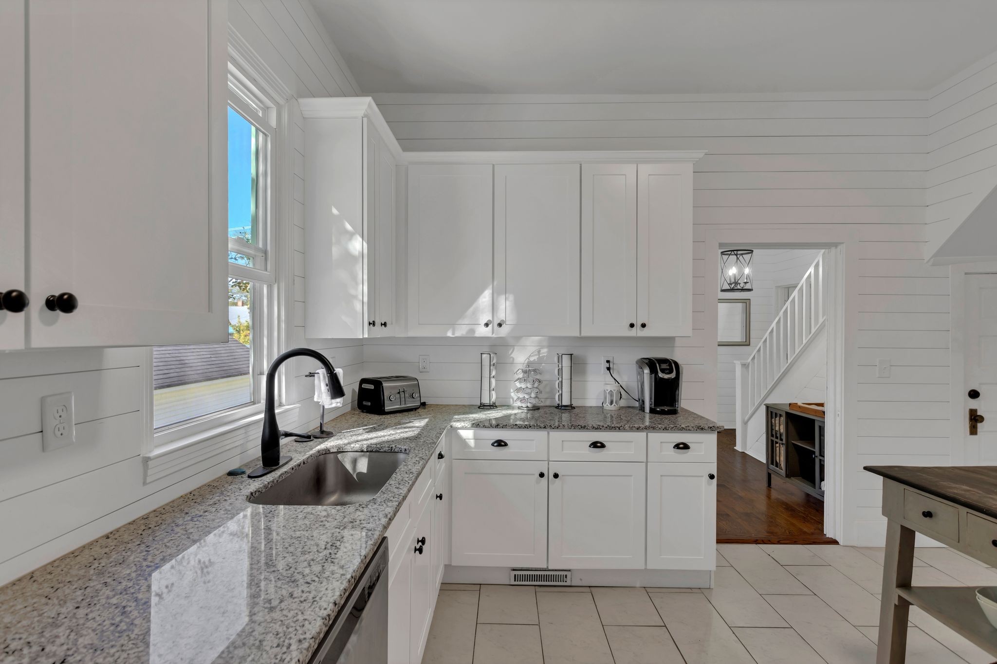 105 3rd Avenue Columbia, TN 38401 - Photo 9 of 21 a kitchen with white cabinets a sink stove and refrigerator