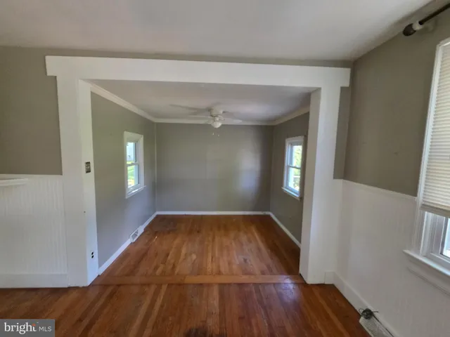 a view of a room with wooden floor and staircase