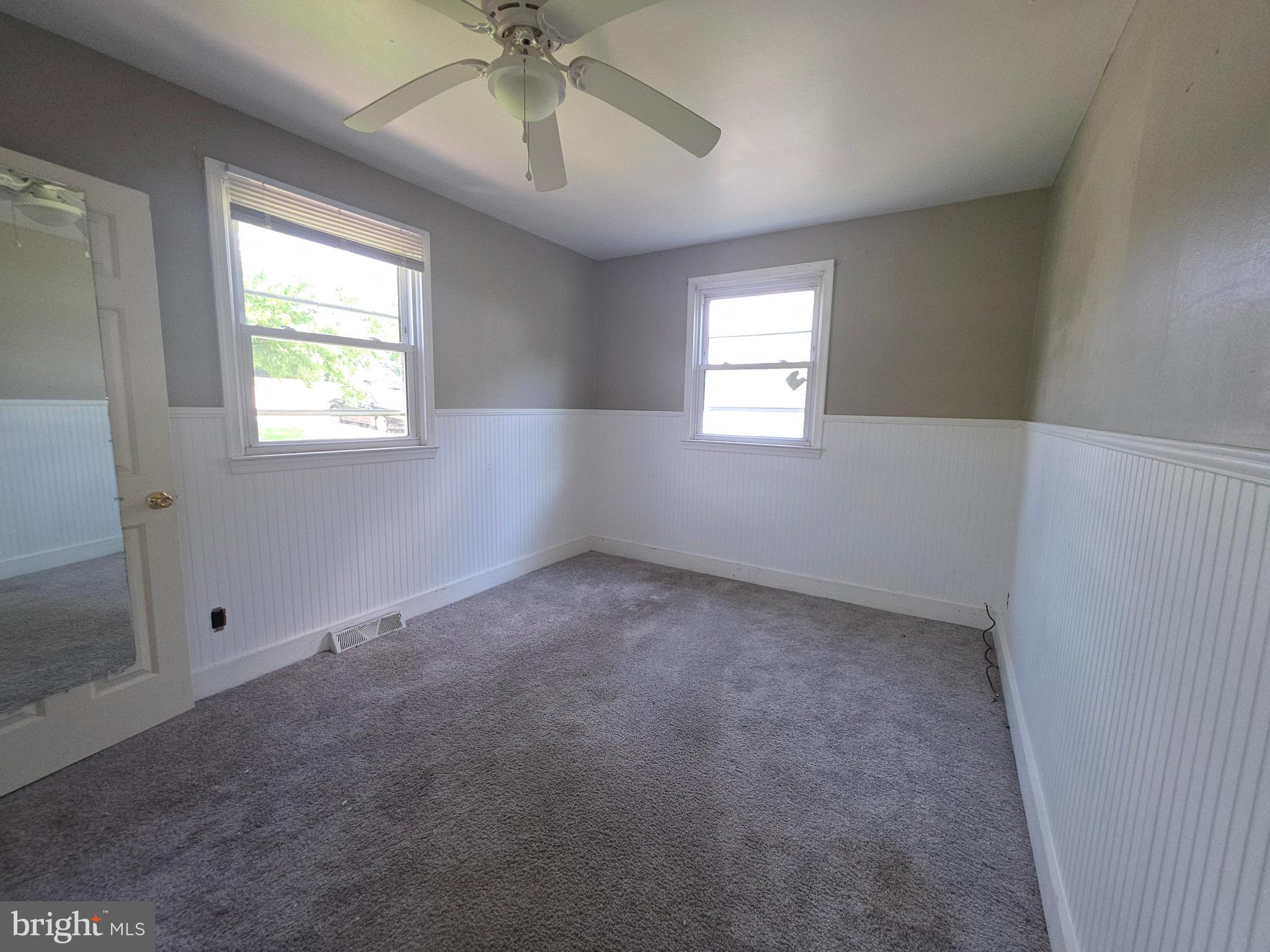 2590 Hallowing Point Road Prince Frederick, MD 20678 - Photo 4 of 10 an empty room with a window and a fan