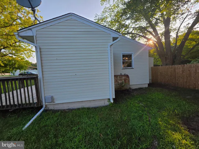 a view of backyard with barbeque grill and a large tree