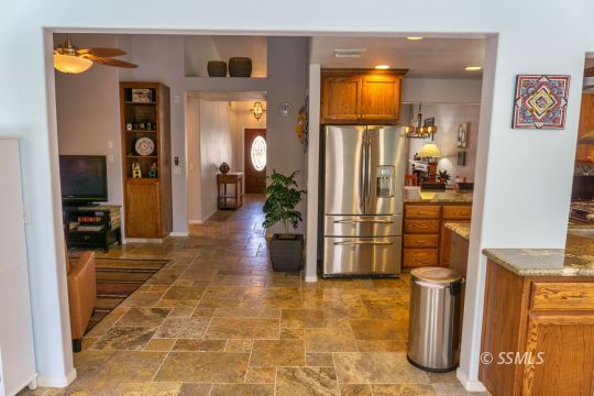 718 La Paloma Street Ridgecrest, CA 93555 - Photo 29 of 50 a view of a hallway with wooden floor and furniture