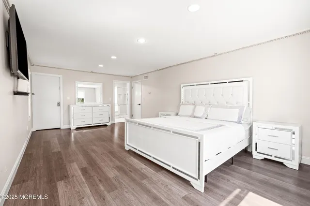 a room with a bed and a flat screen tv