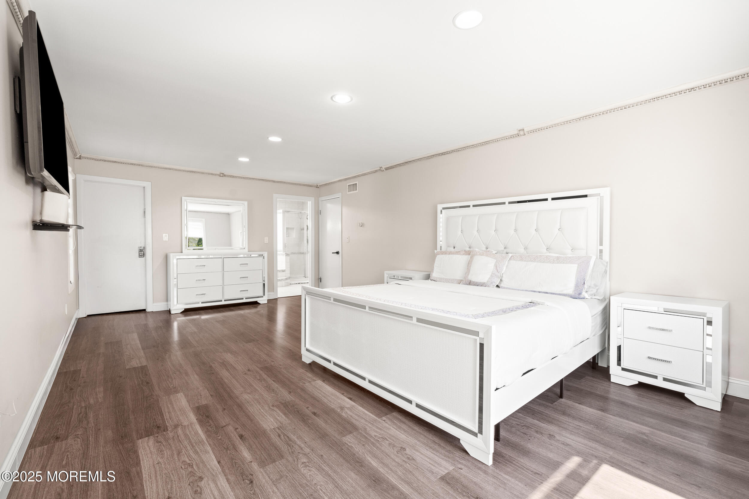 24 Valley Forge Road Eatontown, NJ 07724 - Photo 18 of 23 a room with a bed and a flat screen tv