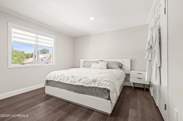 a large bed sitting in a bedroom next to a window