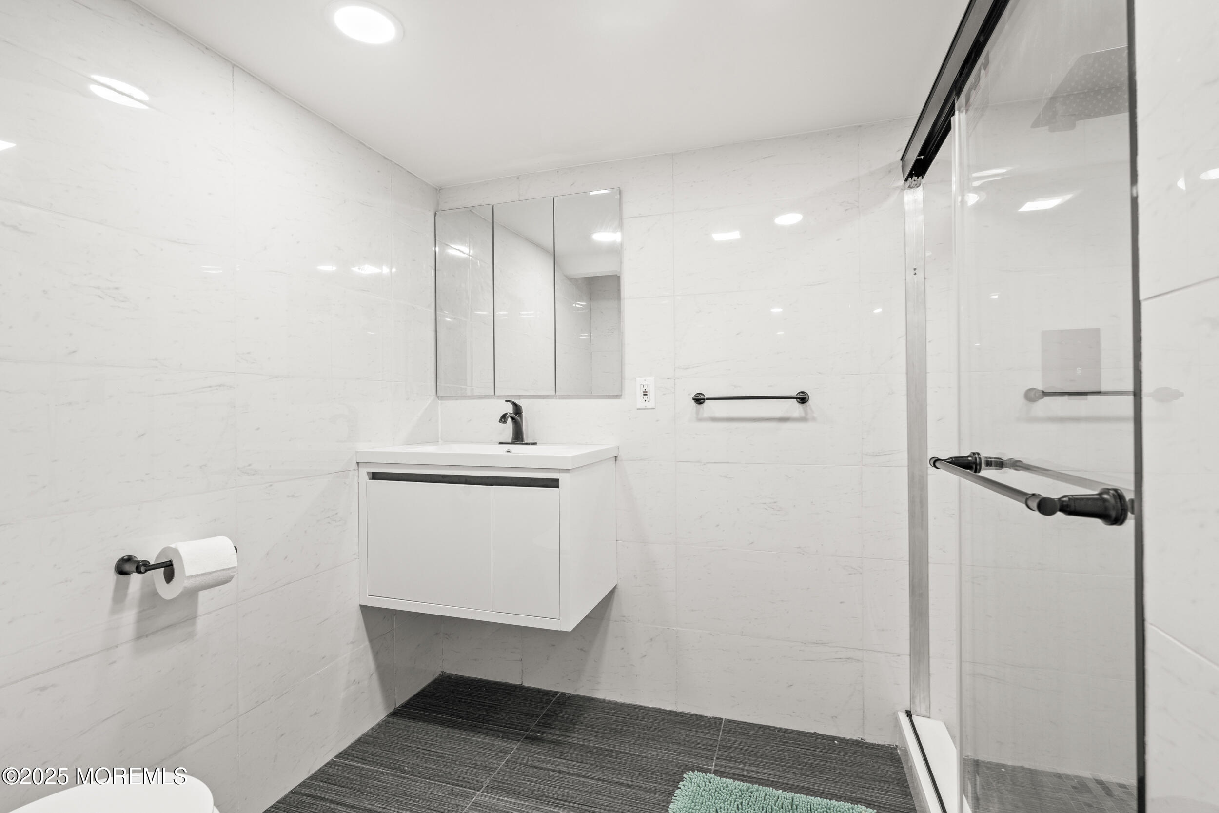 24 Valley Forge Road Eatontown, NJ 07724 - Photo 22 of 23 a bathroom with a sink a toilet a mirror and shower