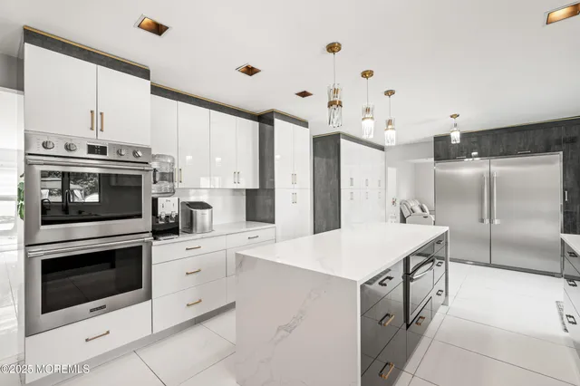 a kitchen with a sink stove and white stainless steel appliances