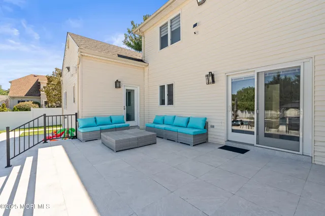 a balcony with furniture and a potted plant