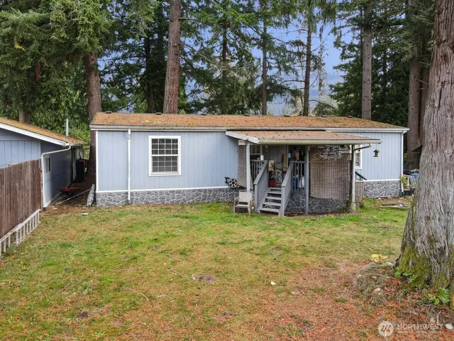 a view of a house with backyard porch and sitting area