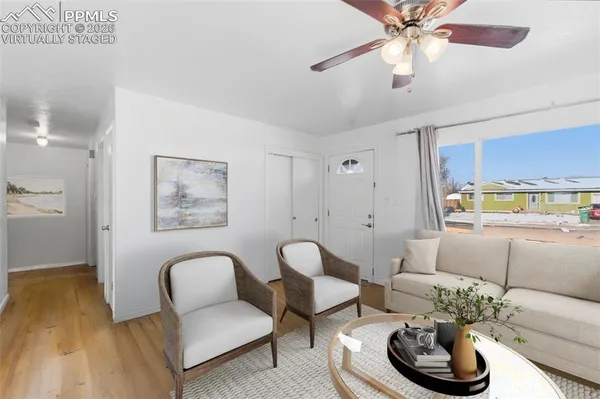a living room with furniture and a potted plant