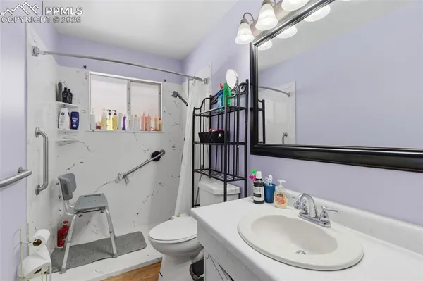 a bathroom with a sink a toilet and a mirror