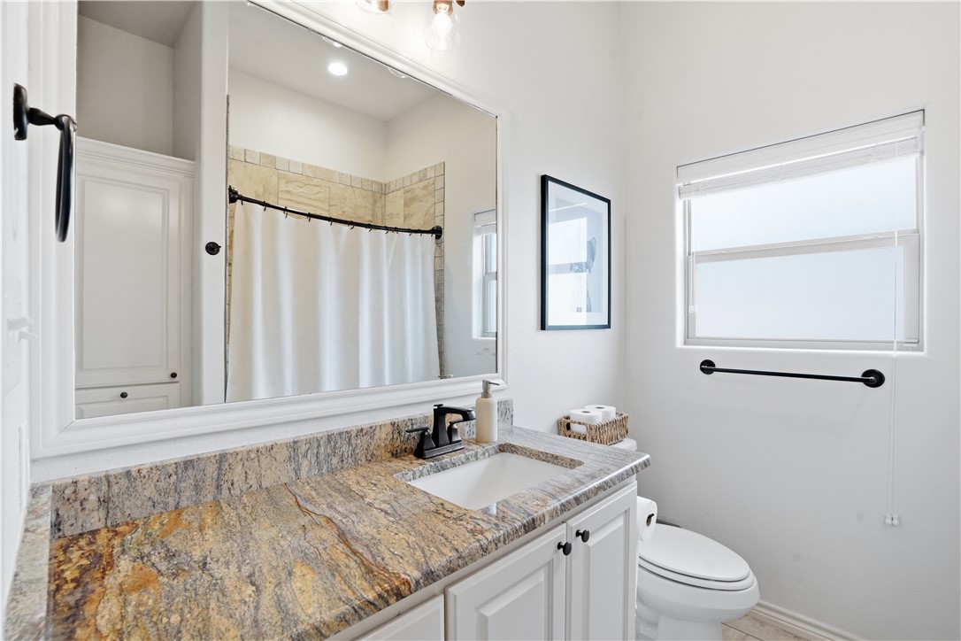 3516 Foxcroft Path Bryan, TX 77808 - Photo 23 of 38 a bathroom with a granite countertop sink toilet and shower