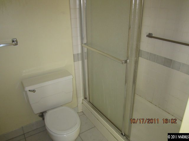 100 North Arlington Avenue, Unit 19H Reno, NV 89501 - Photo 2 of 11 a white toilet sitting next to a shower