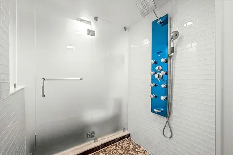 a bathroom with a shower and a shower