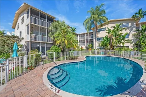 a swimming pool with outdoor seating and yard