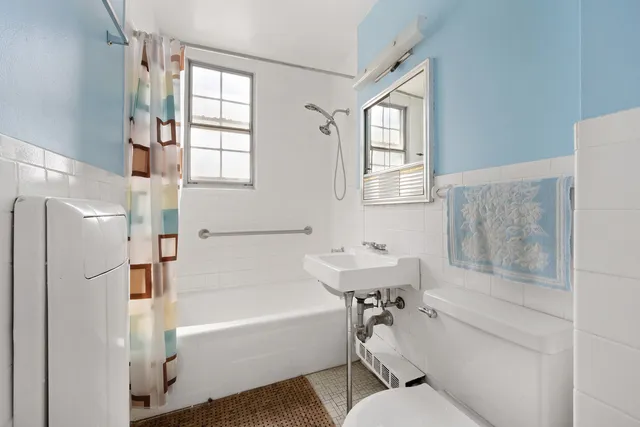 a white kitchen with granite countertop a stove a sink dishwasher and a refrigerator