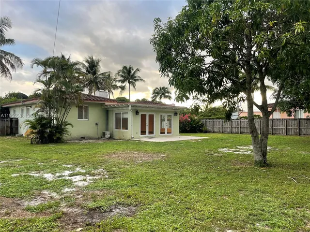 a view of a backyard with a swing