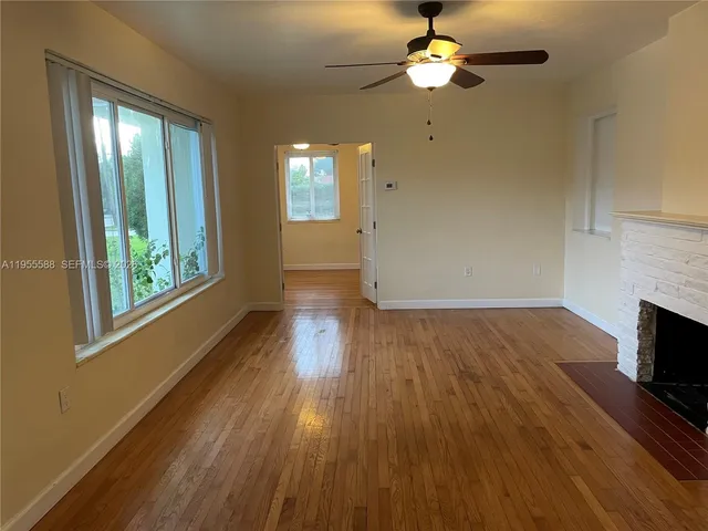 wooden floor in an empty room with a window